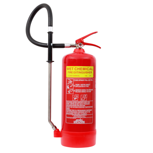 A red wet chemical fire extinguisher with a yellow label